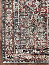 an antique heriz karajah runner with a deep wine red and brown palette and light pink and yellow accents