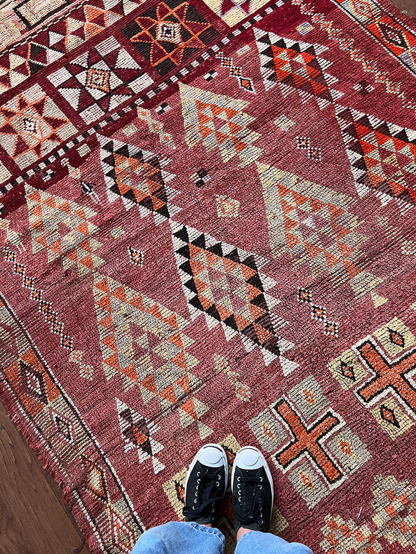 a vintage moroccan rug with a cherry red and pink palette and pretty lilac accents