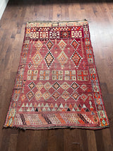 a vintage moroccan rug with a cherry red and pink palette and pretty lilac accents