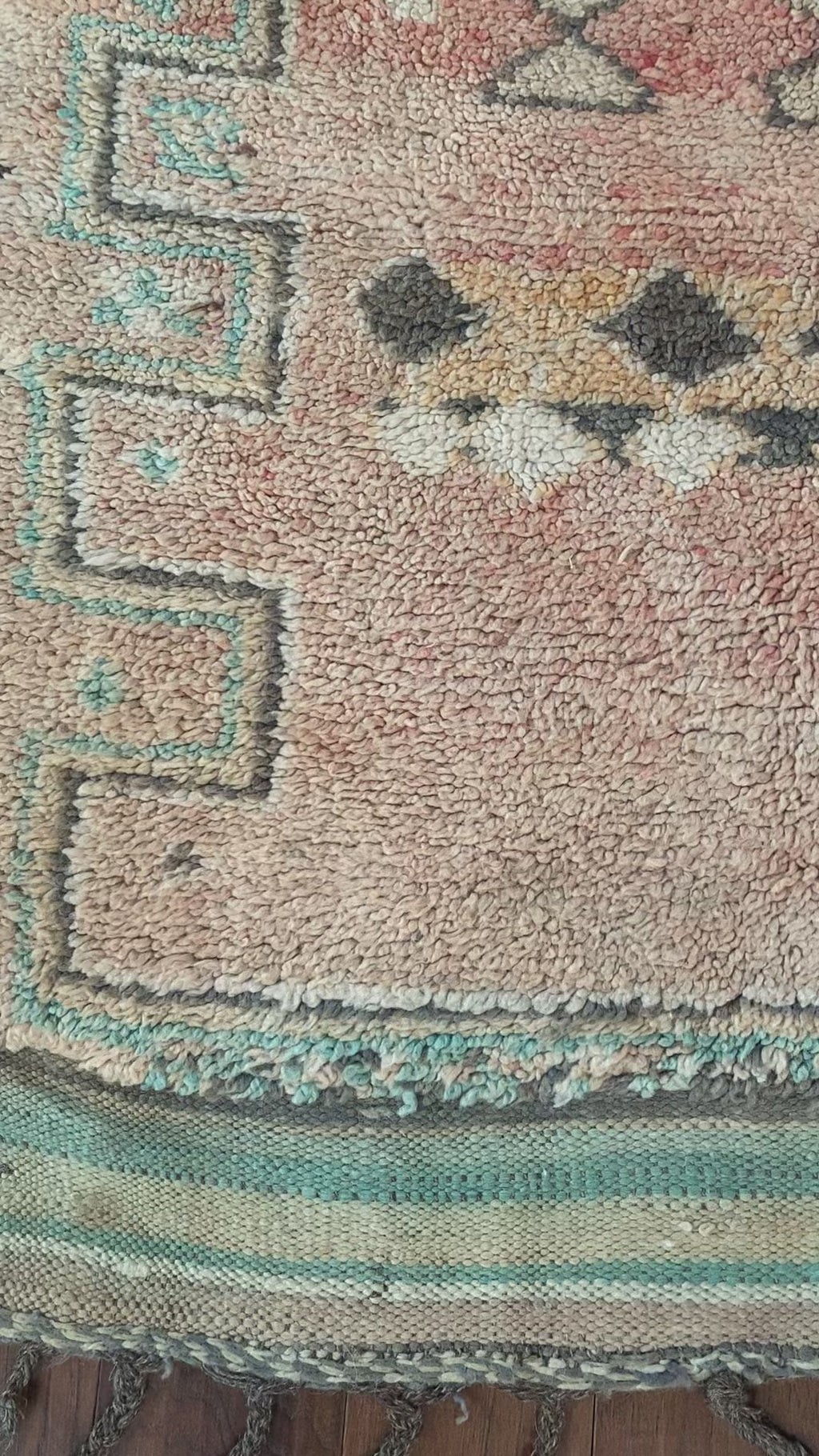 a vintage berber rug with pink abrash and taupe and turquoise accents