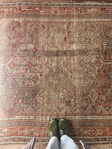 an earthy toned antique shiraz rug with 3 cream medallions
