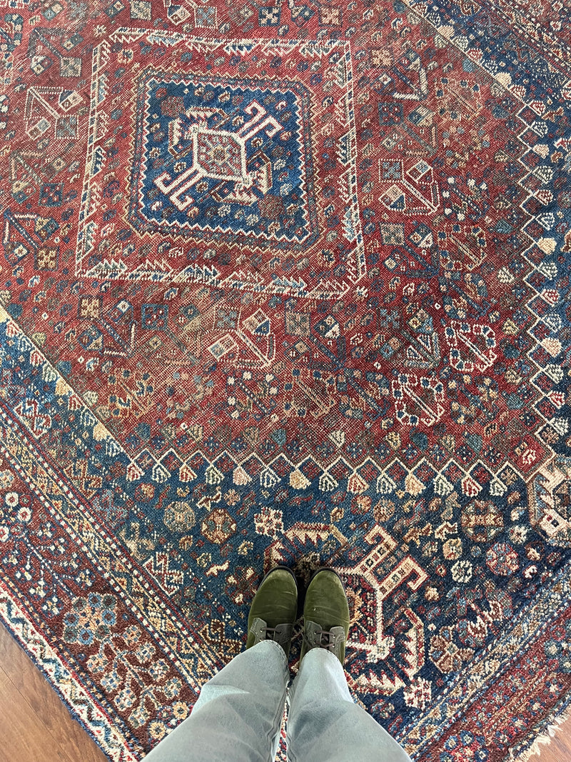 a large vintage shiraz rug with red and blue palette
