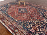 a large vintage shiraz rug with red and blue palette
