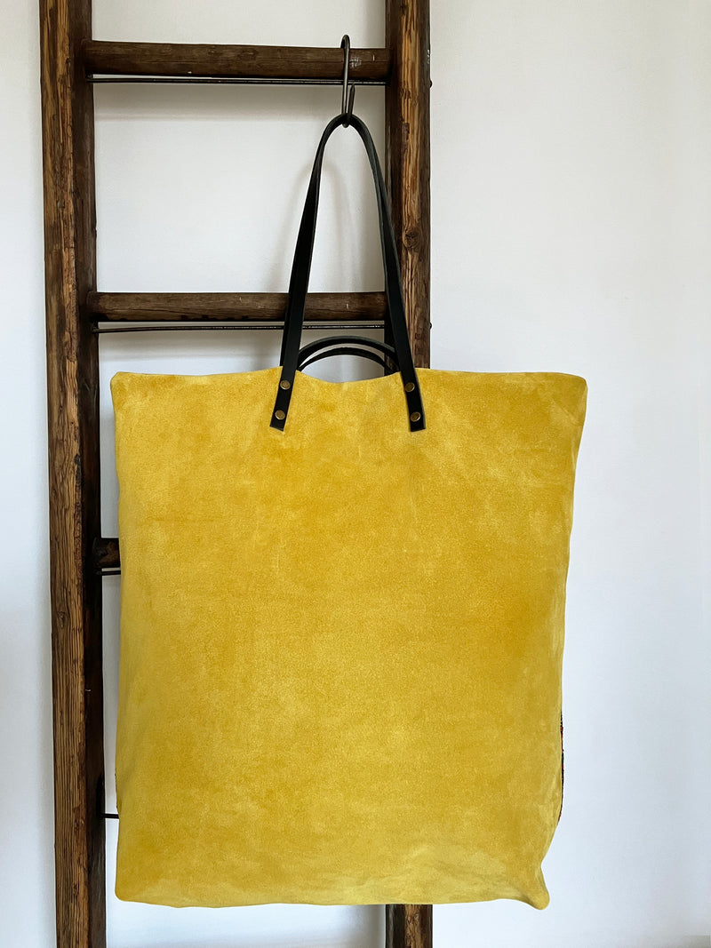 an overnight tote bag with vintage mahal rug and mustard suede leather