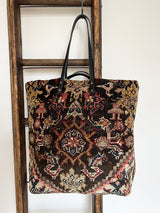 an overnight tote bag with vintage mahal rug and mustard suede leather
