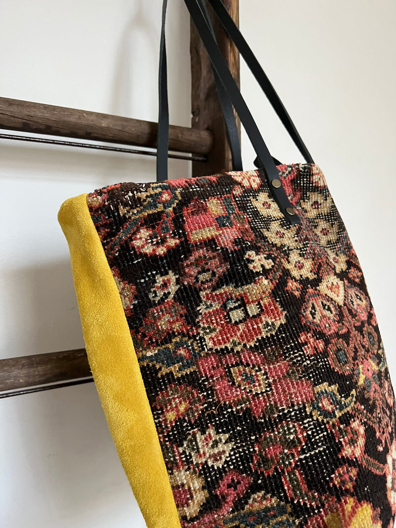 an everyday brownber hall bag with mahal rug and mustard yellow suede