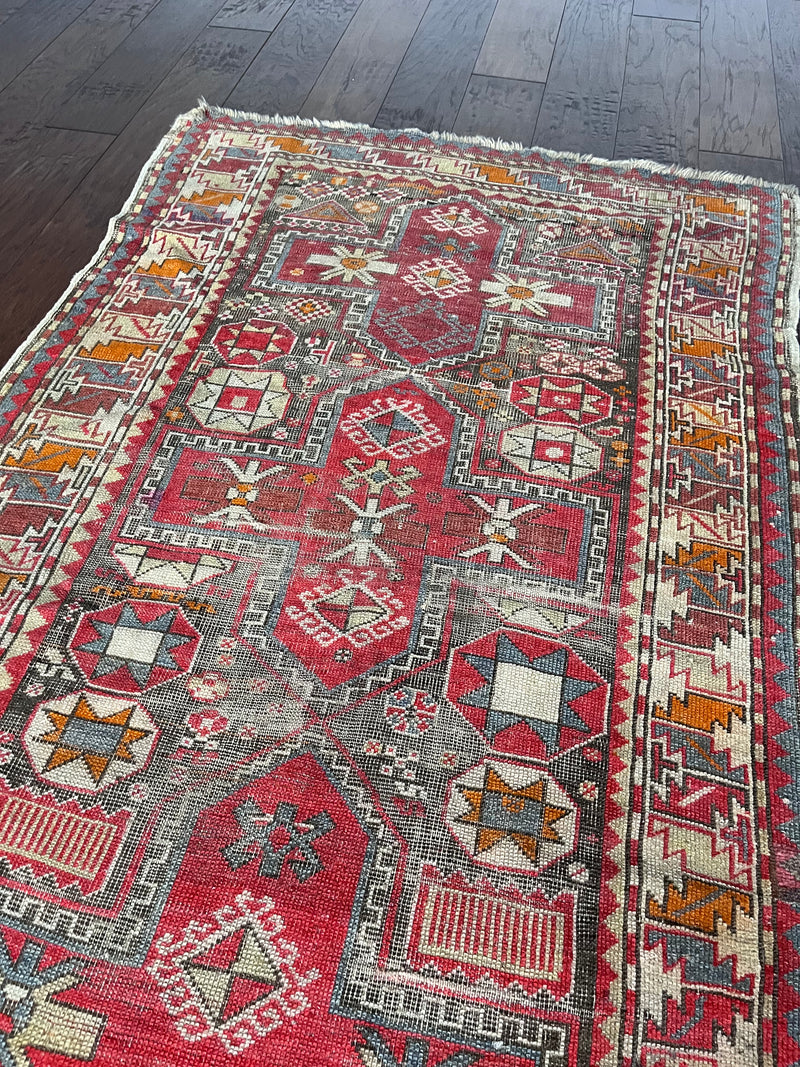 a medium-size caucasian shirwan rug with hot pink accents
