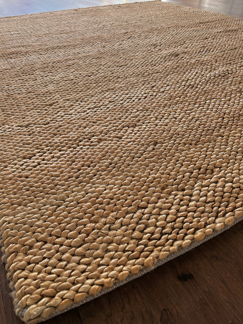 a chunky braided jute rug with ombre caramel tones