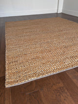 a chunky braided jute rug with ombre caramel tones
