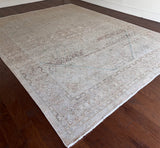 a large mahal rug with a neutral palette and soft teal accents