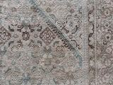 a large mahal rug with a neutral palette and soft teal accents