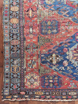 a large antique sumac rug with royal blue central medallions and a red field