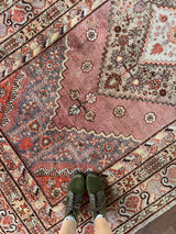an antique Khotan rug with lilac, pink and coral palette