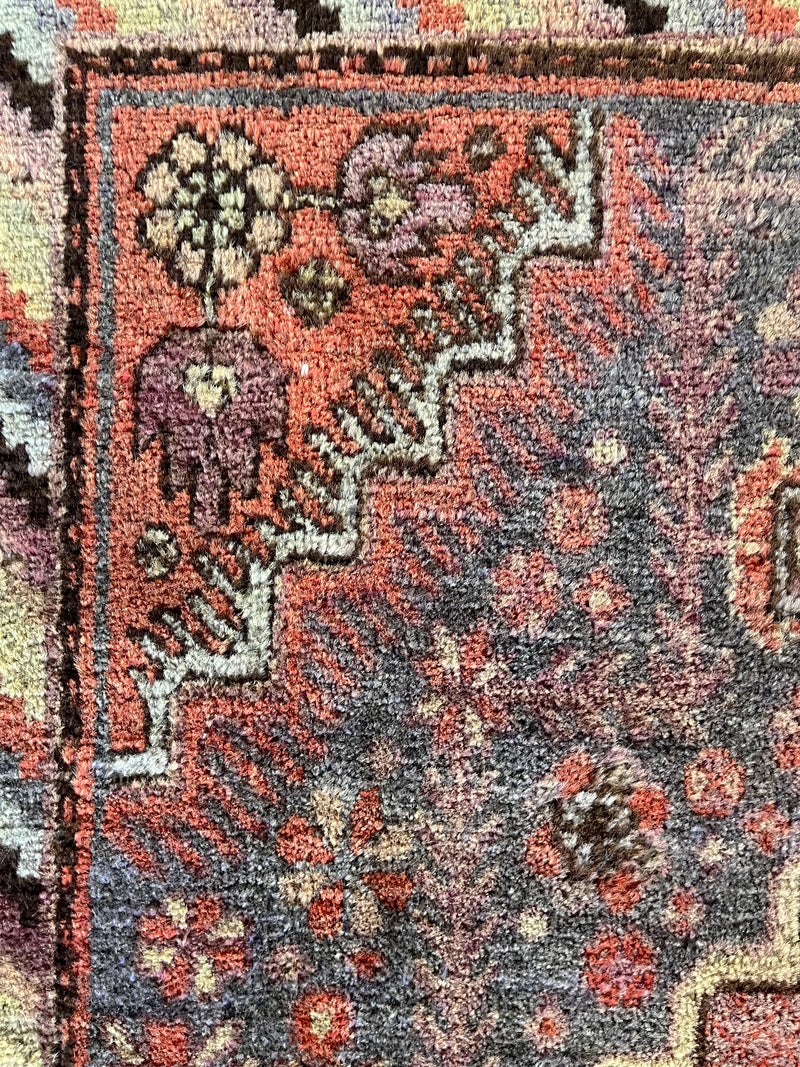 an antique Khotan rug with lilac, pink and coral palette