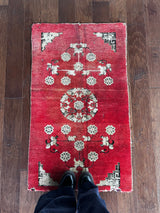 an small antique chinese peking rug with raspberry pink tones
