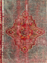 an antique turkish rug with hot pink accents and floral details