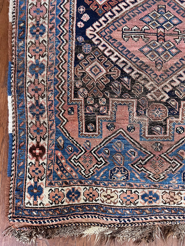 A mini vintage Afshar rug with blue and dusty pink details