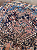 A mini vintage Afshar rug with blue and dusty pink details