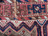 an antique shiraz qashqai rug with a pretty pink details and a royal blue zig zag border