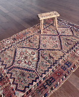 an antique shiraz qashqai rug with a pretty pink details and a royal blue zig zag border