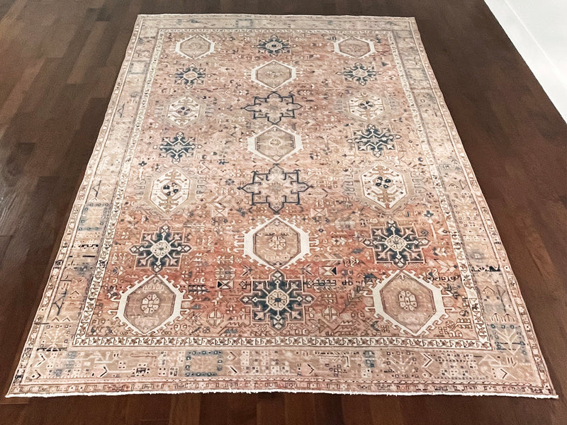 a large heriz rug with soft coral and powder blue tones