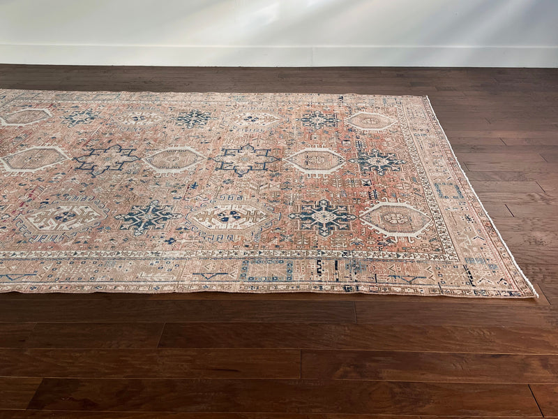 a large heriz rug with soft coral and powder blue tones