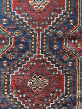a mini antique shiraz rug with a classic red and blue palette