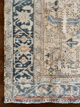 an antique malayer rug with a neutral field and baby blue and coral accents