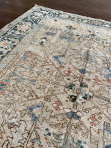 an antique malayer rug with a neutral field and baby blue and coral accents