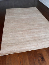 a hand braided jute rug in natural undyed sisal