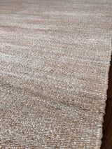 a hand braided jute rug in natural undyed sisal