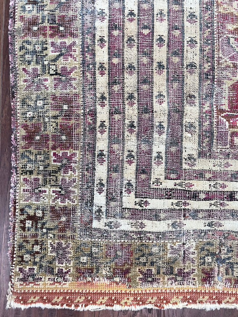 an antique turkish prayer rug with beautiful lilac tones
