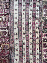 an antique turkish prayer rug with beautiful lilac tones