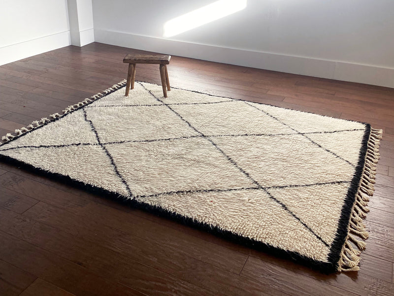 a vintage beni ourain rug with large black diamond pattern