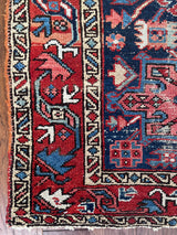 a mini antique heriz rug with colorful palette