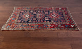 a mini antique heriz rug with colorful palette