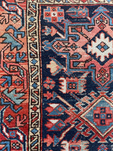 a mini antique heriz rug with colorful palette