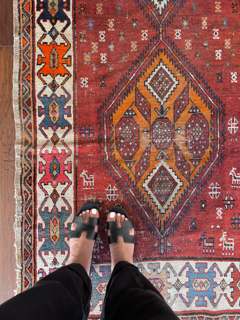 Nora: an antique Heriz runner circa 1920, with a terracotta field and bright neon medallions