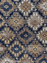 a medium size caucasian rug with a blue, brown and cream palette
