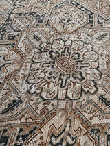 A large antique Heriz rug neutral palette and dark brown medallion. 