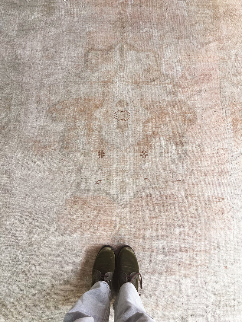 a vintage turkish rug with soft salmon hues and a fawn accents
