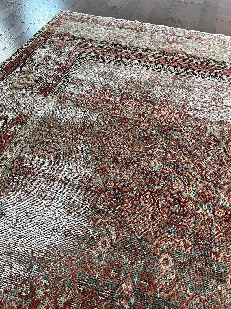 an antique heirloom mahal rug with teal and brown tones and fine floral palette