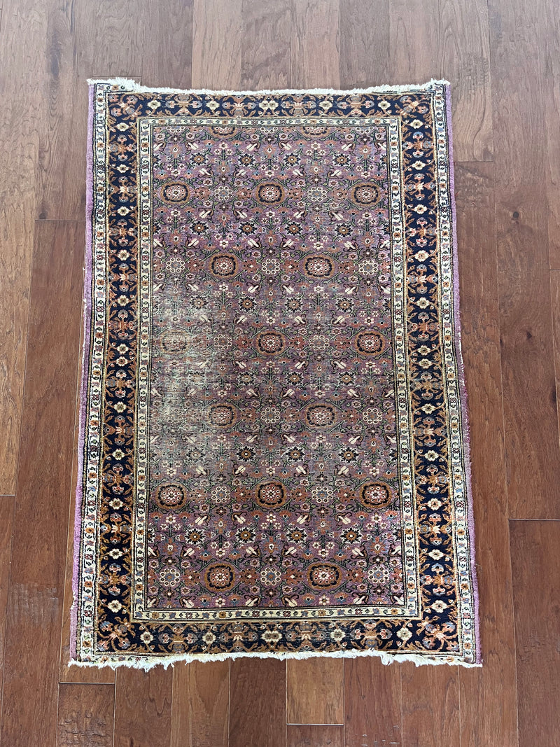 a vintage turkish rug with a lilac field and pretty floral pattern