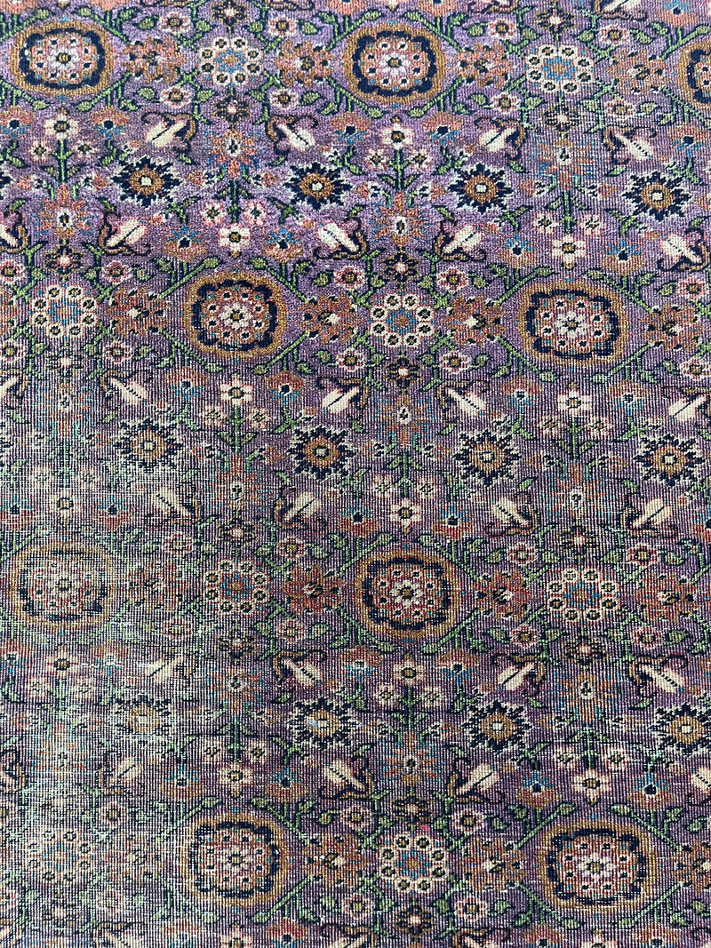 a vintage turkish rug with a lilac field and pretty floral pattern