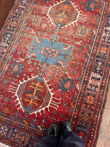 a vintage Heriz rug circa 1940. With red and raspberry tones 