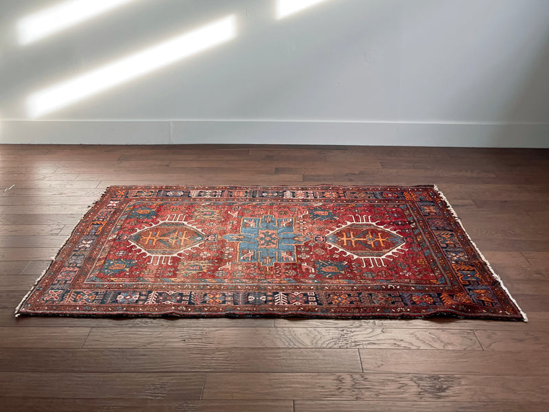 a vintage Heriz rug circa 1940. With red and raspberry tones 