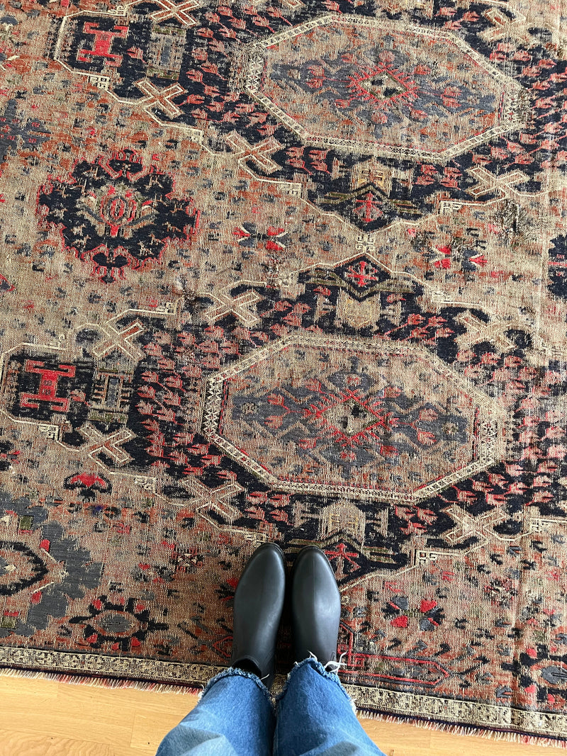 a very fine antique sumac rug with a taupe field and dark blue and bright pink accents