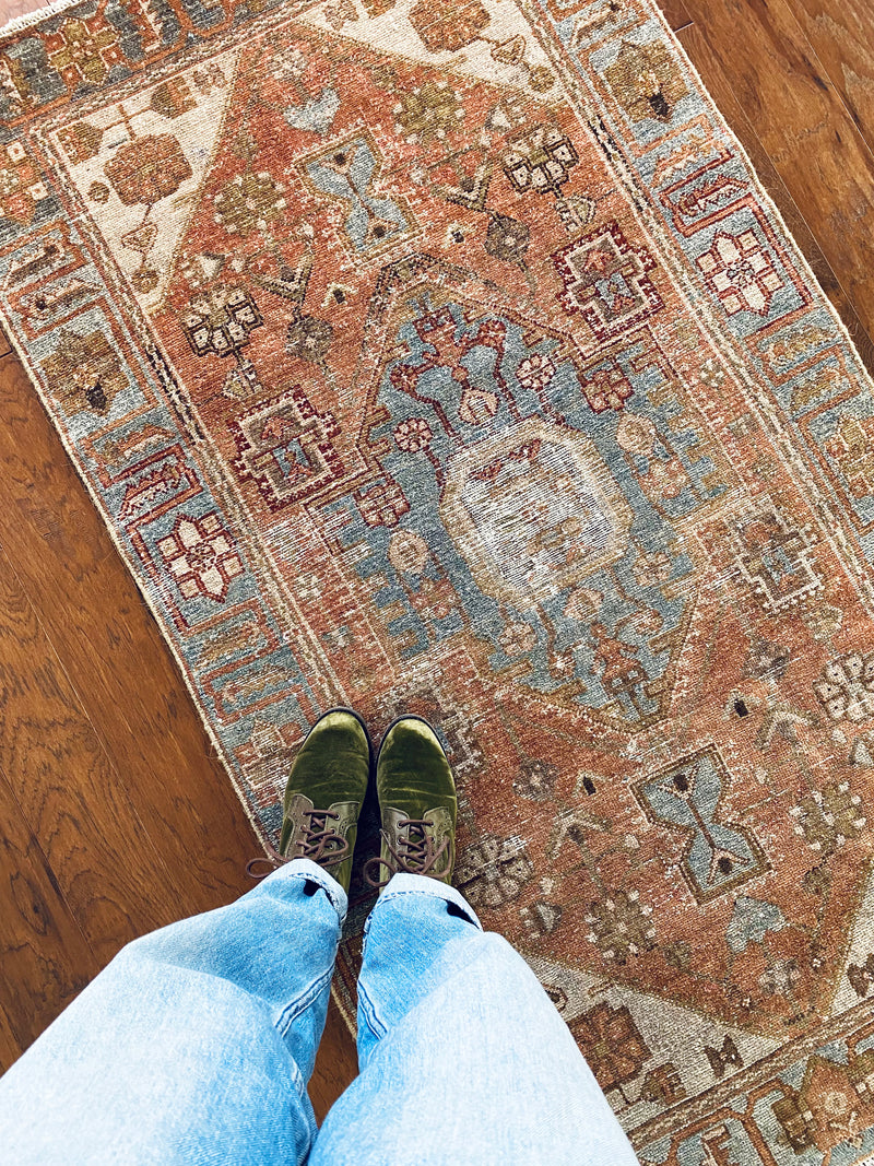 an antique malayer rug with a coral field and icy blue accents
