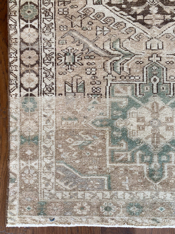 an antique heriz runner with a neutral palette and subtle sea green accents