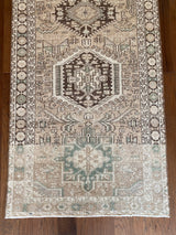 an antique heriz runner with a neutral palette and subtle sea green accents